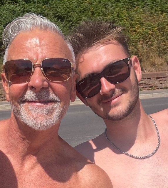 Tyrone and his son together outdoors wearing sunglasses